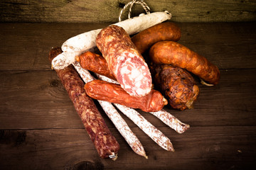 several types of sausages on a wooden background