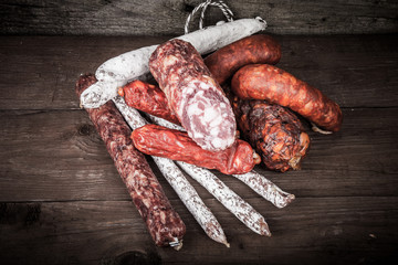 several types of sausages on a wooden background