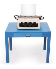 Retro style typewriter with paper on office desk.