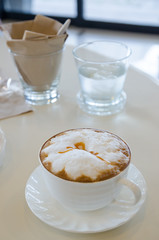 cup of cappuccino in a white cup on table