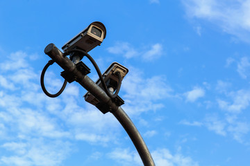 Fototapeta premium Security camera on blue sky background