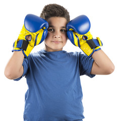 Little boy wearing blue boxing gloves