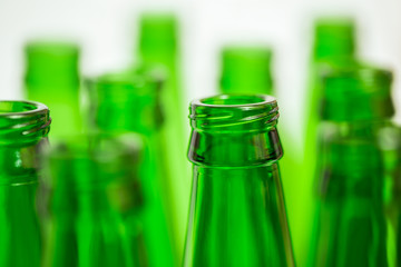 Ten Green Bottle Necks, One Bottle in Focus on Foreground.