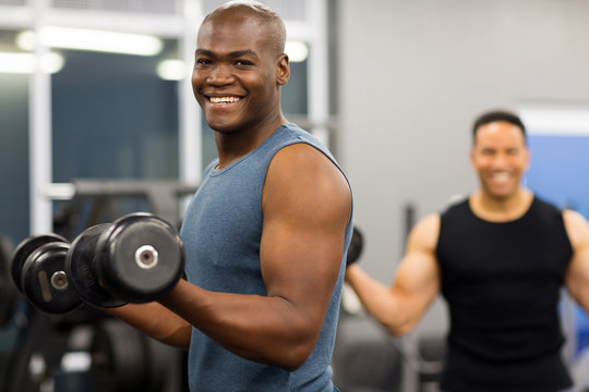 African Man Working Out With Dumbbells