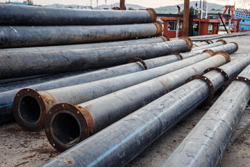 Stack of Large PVC Pipes on the road