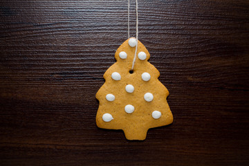 Christmas cookies hanging over wooden background