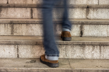 man walking up an old stone staircase © Pink Badger