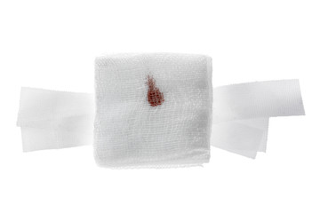 Gauze bandage with blood on white.