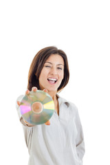 casual smiling woman holding up compact disc or cd  and looking