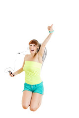 Girl with earphones jumping of joy listening to music