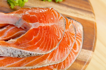 Delicious  portion of fresh salmon fillet on a wooden board