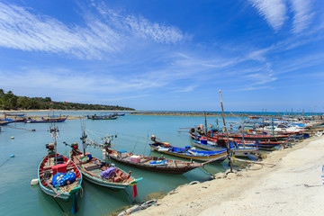 Naklejka na ściany i meble Traditional Thai boat or long tail boat stand at the beach