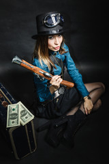 beautiful steampunk woman with bag and gun on black.