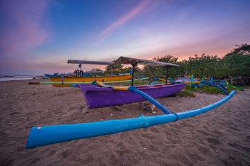 Fototapeta premium Bali traditional boat in the morning sunrise, Kuta beach in Bali island, Indonesia, Asia