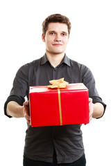 Holiday. Man giving red gift box with golden ribbon