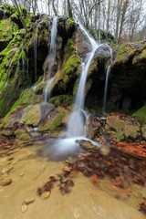 Obraz premium Beautiful waterfalls and autumn foliage in the forest