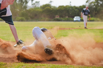 Baseball player sliding into third base © PicMedia