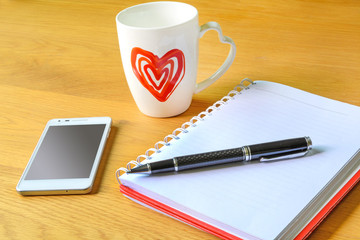 Open a blank white notebook and cup of coffee