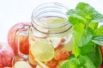 Mug delicious refreshing drink of apple fruits with mint on wood