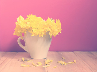 Vintage,yellow flowers in cup