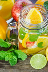 Mug delicious refreshing drink of orange fruit with mint on wood