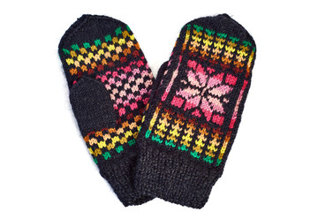 Knitted mittens on white background