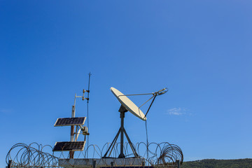 satellite dish at tidal gauge station with text in Thai language