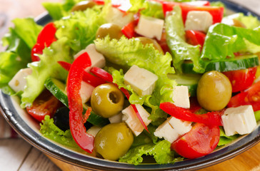 Fresh greek  salad with feta and vegetables .