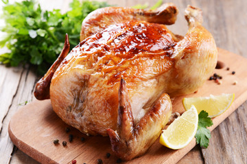 Delicious baked chicken on table close-up