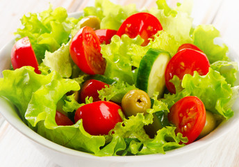 Fresh  vegetables salad in a white bowl.
