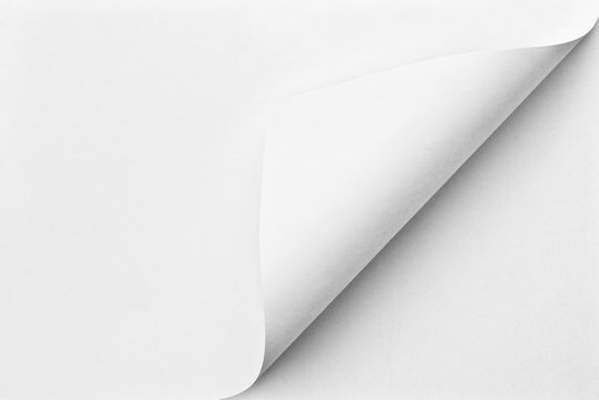 Blank folded sheet of paper with curled corner
