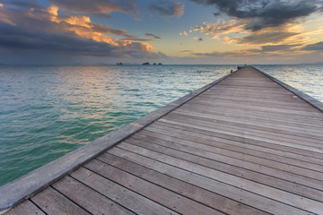 Wood bridge to the sea at sunset beach in Koh Samui, Thailand