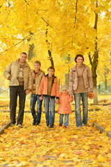 Happy family in autumn forest