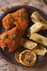 chicken wings in batter closeup with garnish, top view vertical