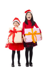 happy little girls showing christmas gift box