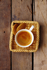 close up hot latte and cookie on wooden table