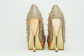 Gold shoes with spikes.