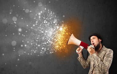 Guy shouting into megaphone and glowing energy particles explode