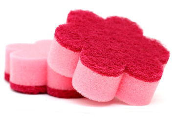 Close up view of a pink cleaning sponge isolated on a white back