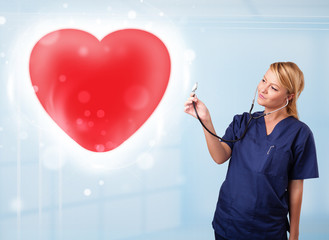 Young nurse healing a red heart