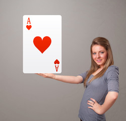 Beautifu woman holding a red heart ace