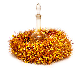 Glass decanter and Christmas tinsel on an isolated background