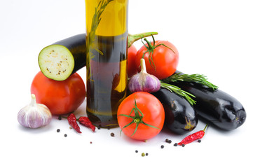 Fresh vegetables and olive oil bottle isolated on a white