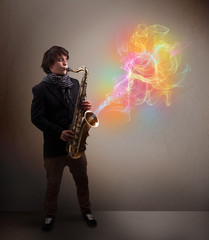 Attractive musician playing on saxophone with colorful abstract