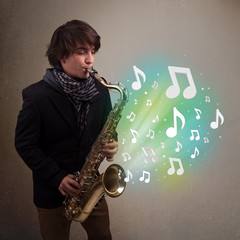 Young musician playing on saxophone while musical notes explodin