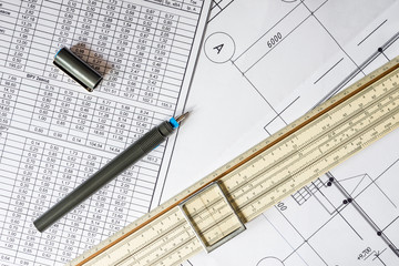 Drawing house plan, slide rule and pencil on the table