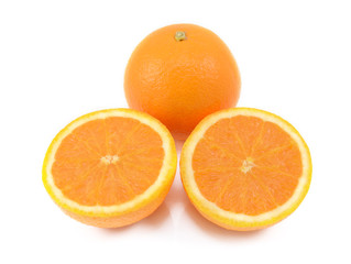 Fototapeta na wymiar Whole orange and two juicy cut halves
