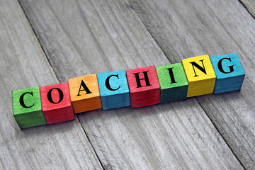concept of coaching word on wooden colorful cubes - obrazy, fototapety, plakaty