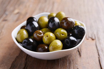 Different marinated olives on table close-up