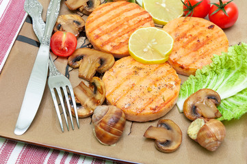 appetizing fried medallions of salmon, stuffed snails with mushr